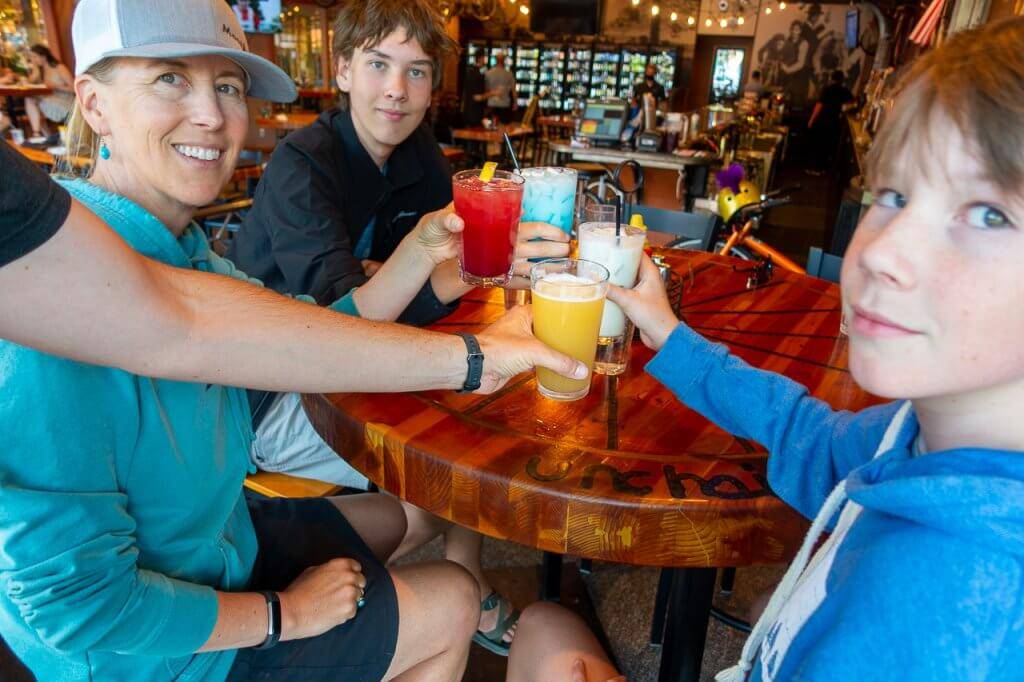 four people cheers-ing with glasses 