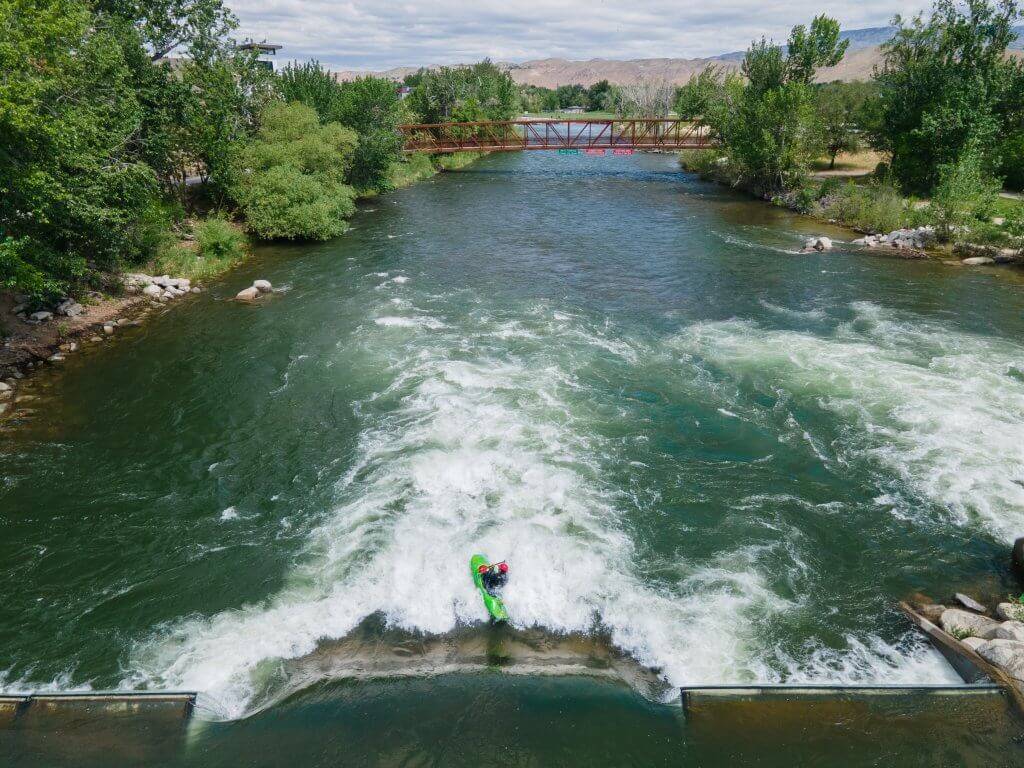 aerial view of river with surfer on rapid