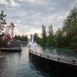 Wide shot of Silverwood Theme Park with rollercoaster track and Roaring Creek Log Flume.