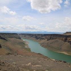 A river running through a deep canyon that levels out on the top.