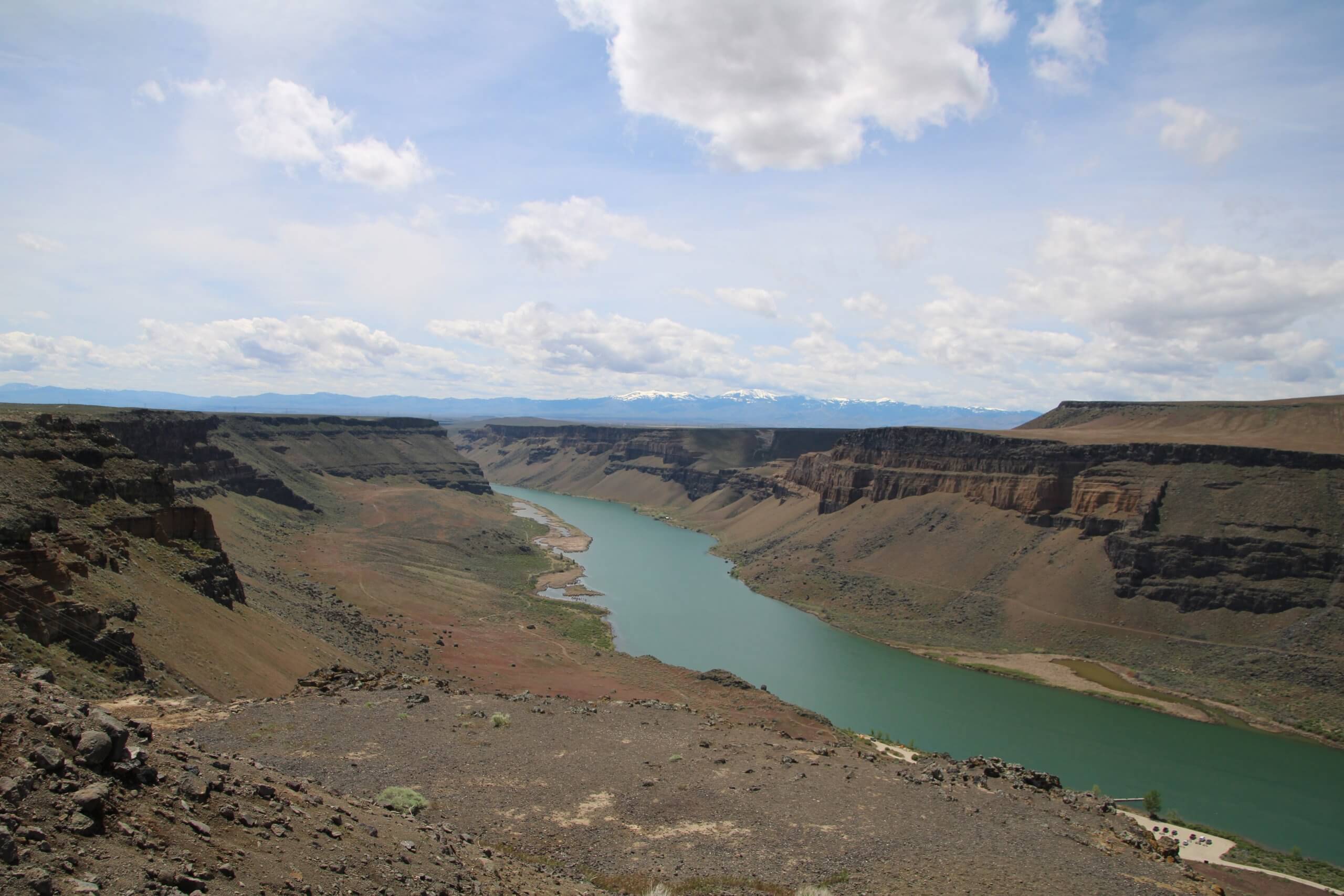 A river running through a deep canyon that levels out on the top.