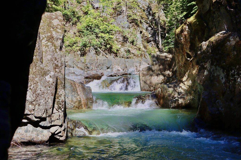 water at Grouse Creek Falls cascades down several rock faces