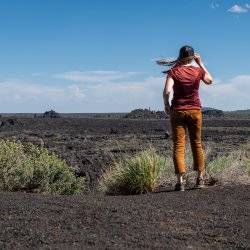 woman overlooking lava field at craters of the moon