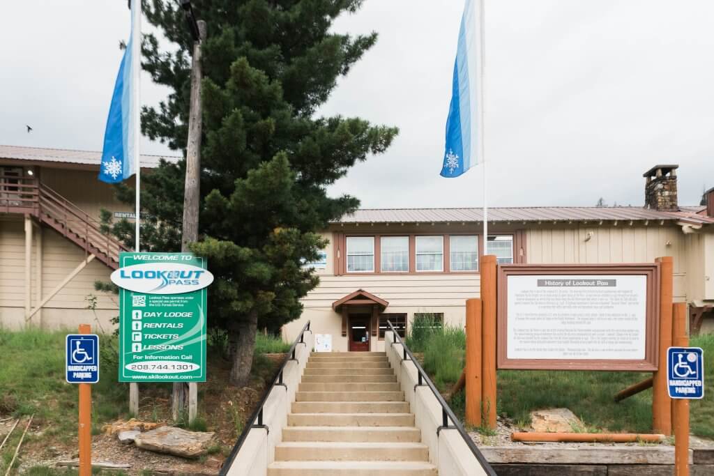 exterior of Lookout Pass office with historical signage out front