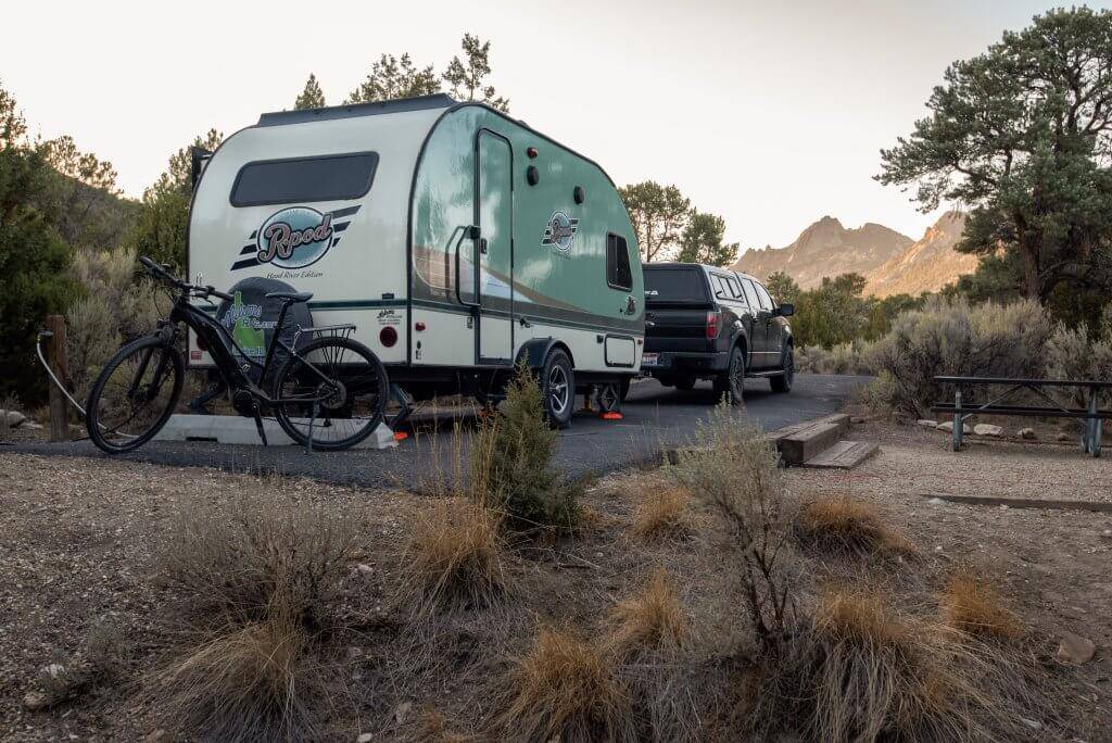 small camper hooked to large black truck in developed campsite at Castle Rocks State Park