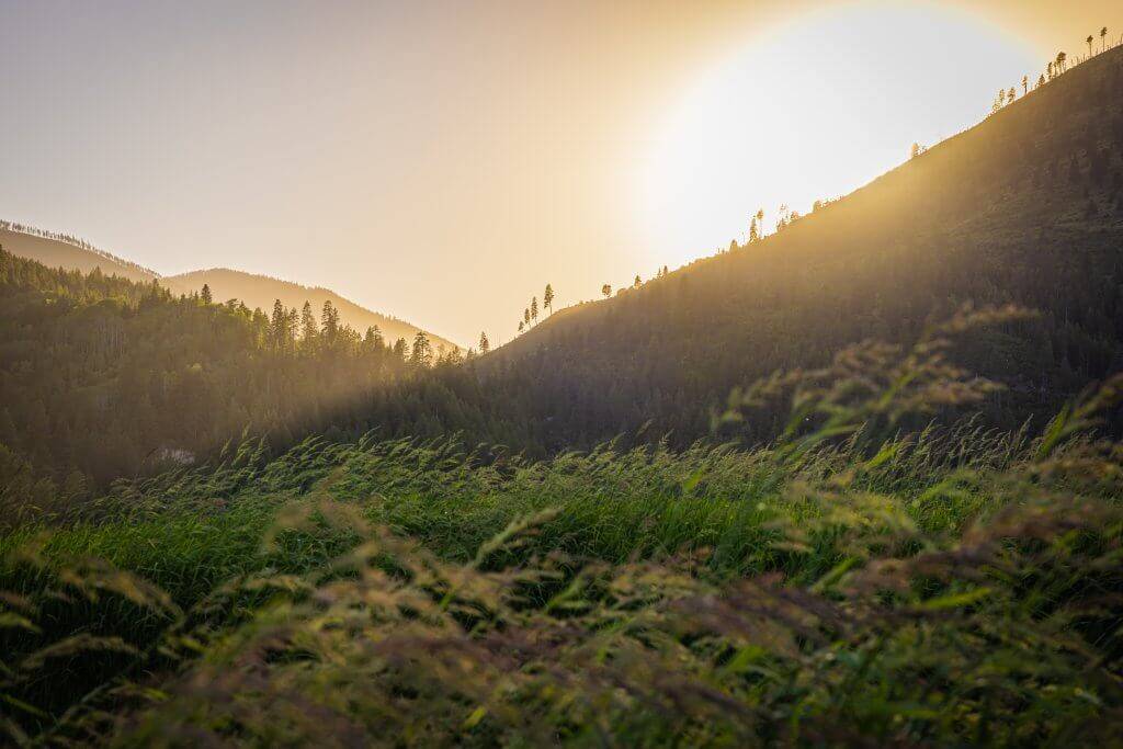 A scenic shot of the mountains with the sun rising behind them in the Kootenai Wildlife Refuge.