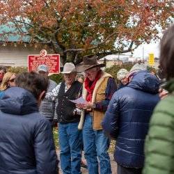 a group of people gathered around red arborgylph sign