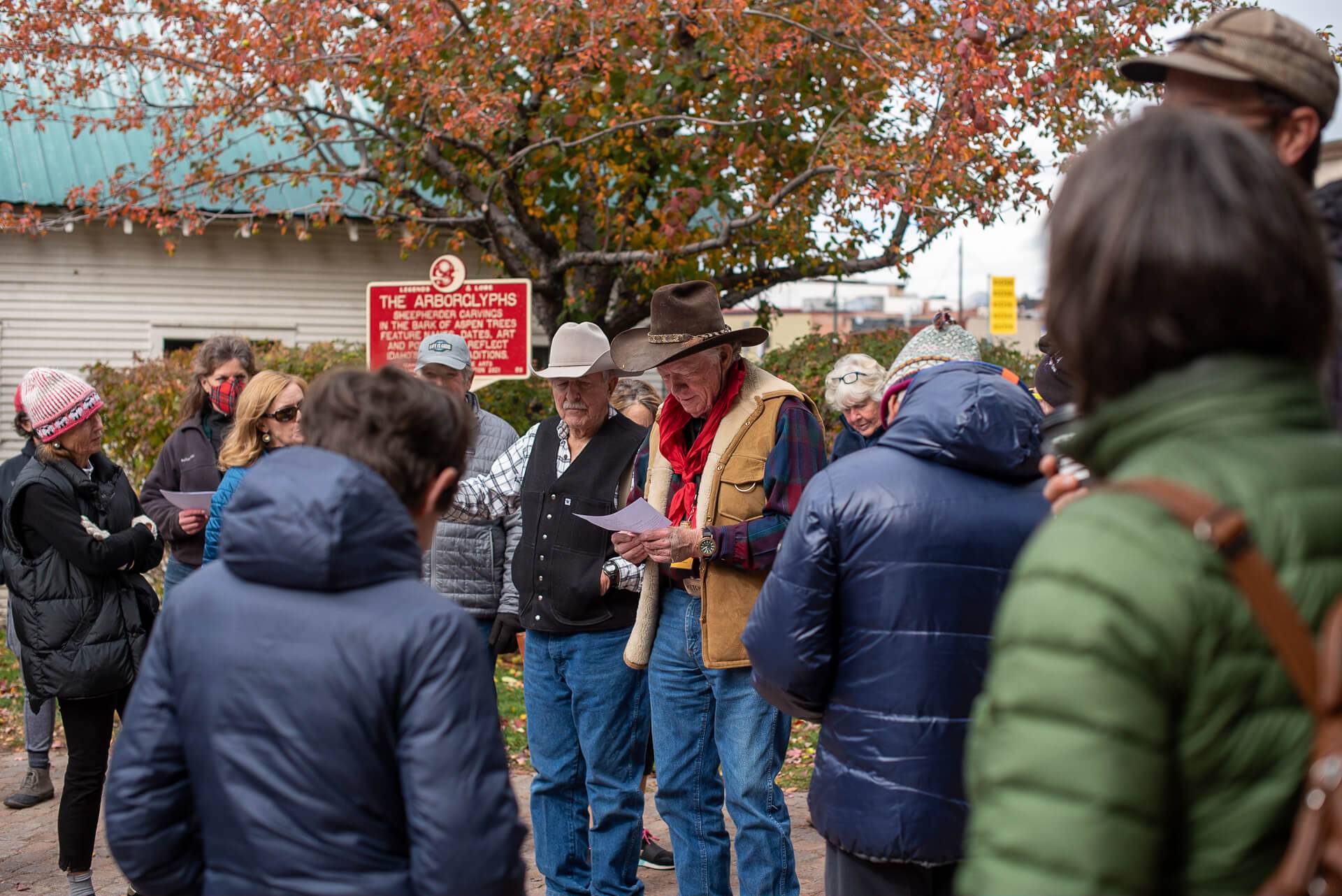 a group of people gathered around red arborgylph sign