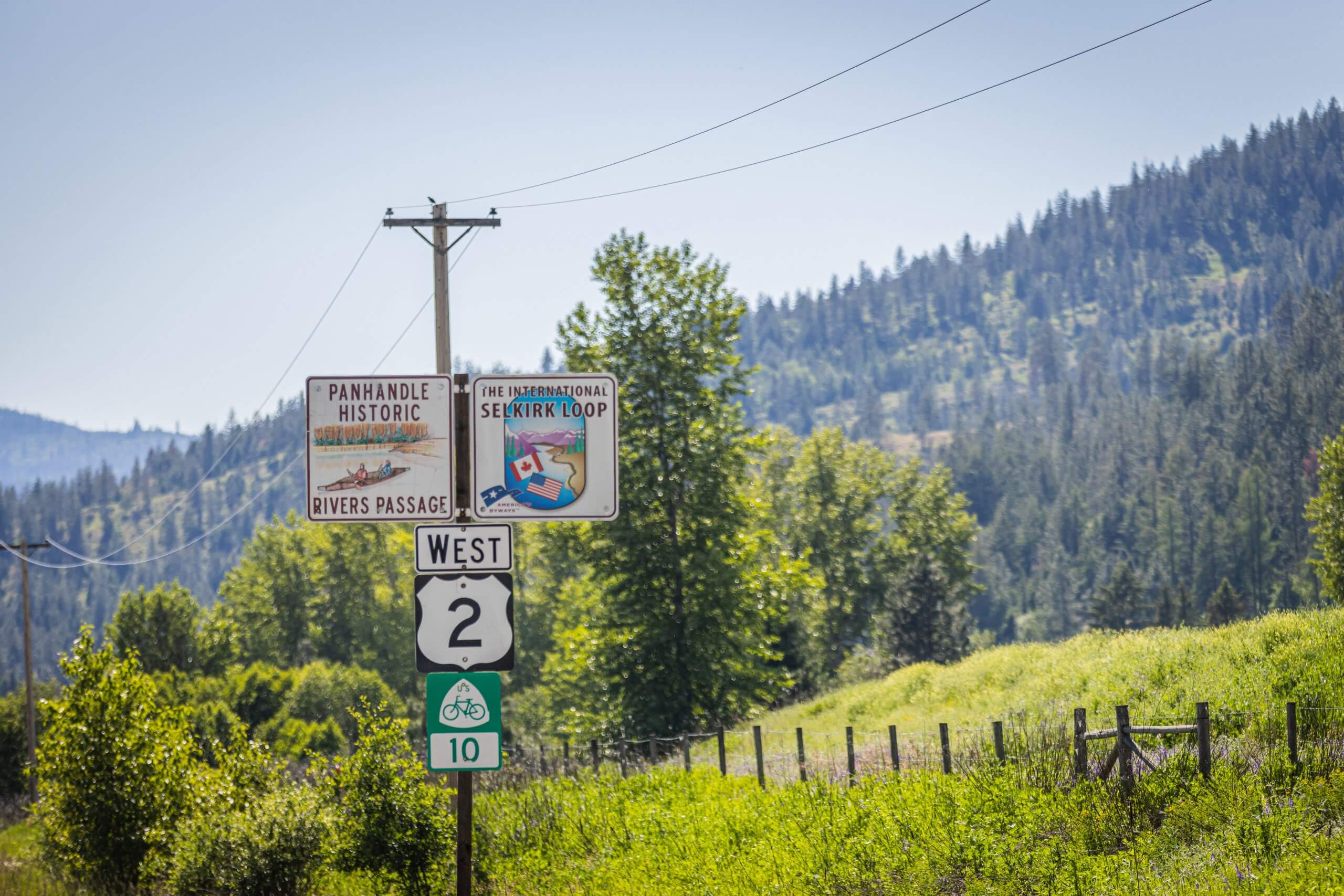 Road signs on the side of the road near Priest River, Idaho.