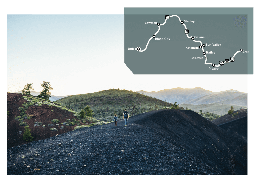 An adult and child walking in Craters of the Moon National Monument. 