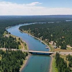 McCrea bridge crossing the tree-lined henry's fork of the snake river.