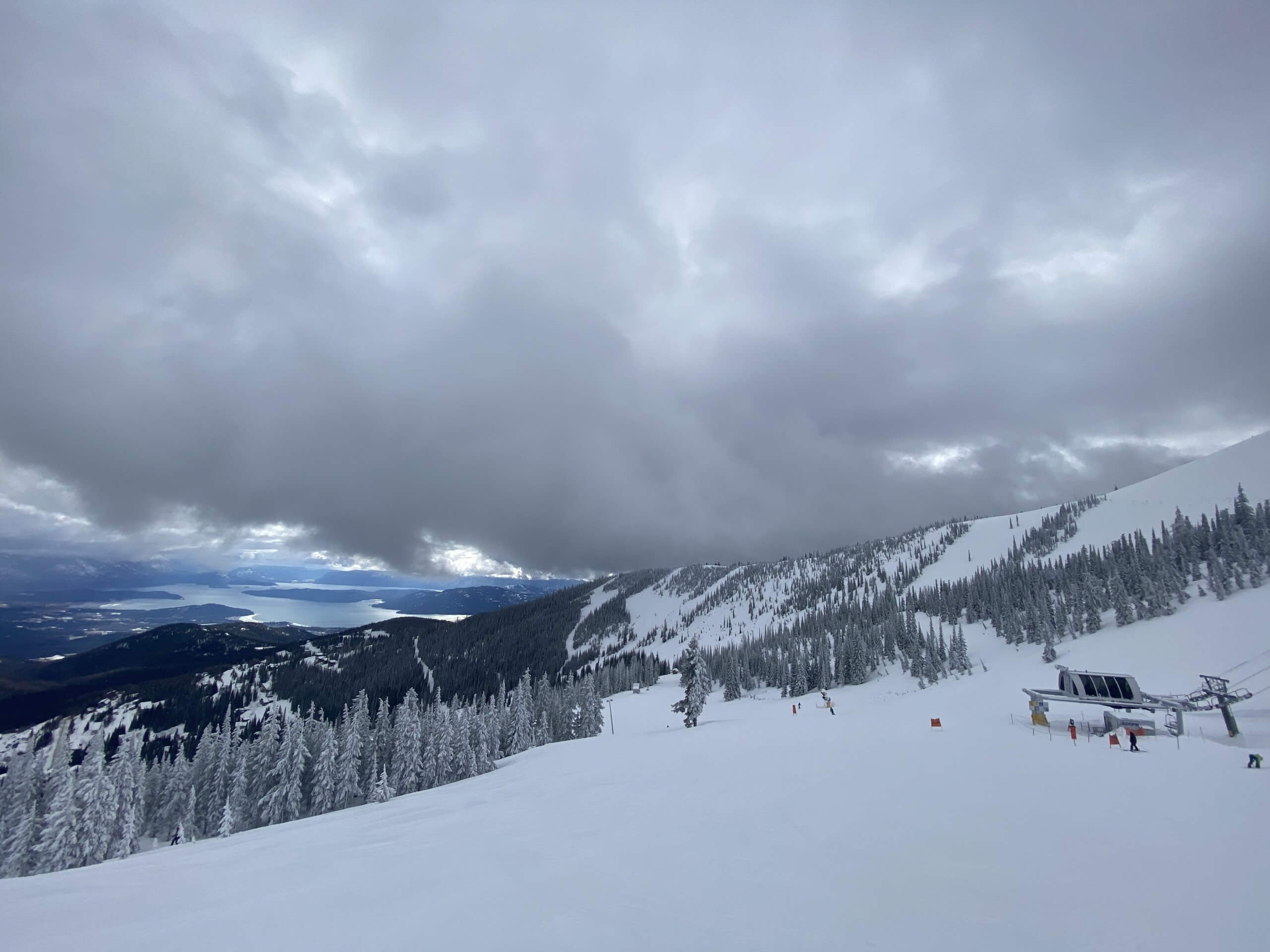 looking out from top of snowy Schweitzer looking down at Lake Pend Oreille in the distance