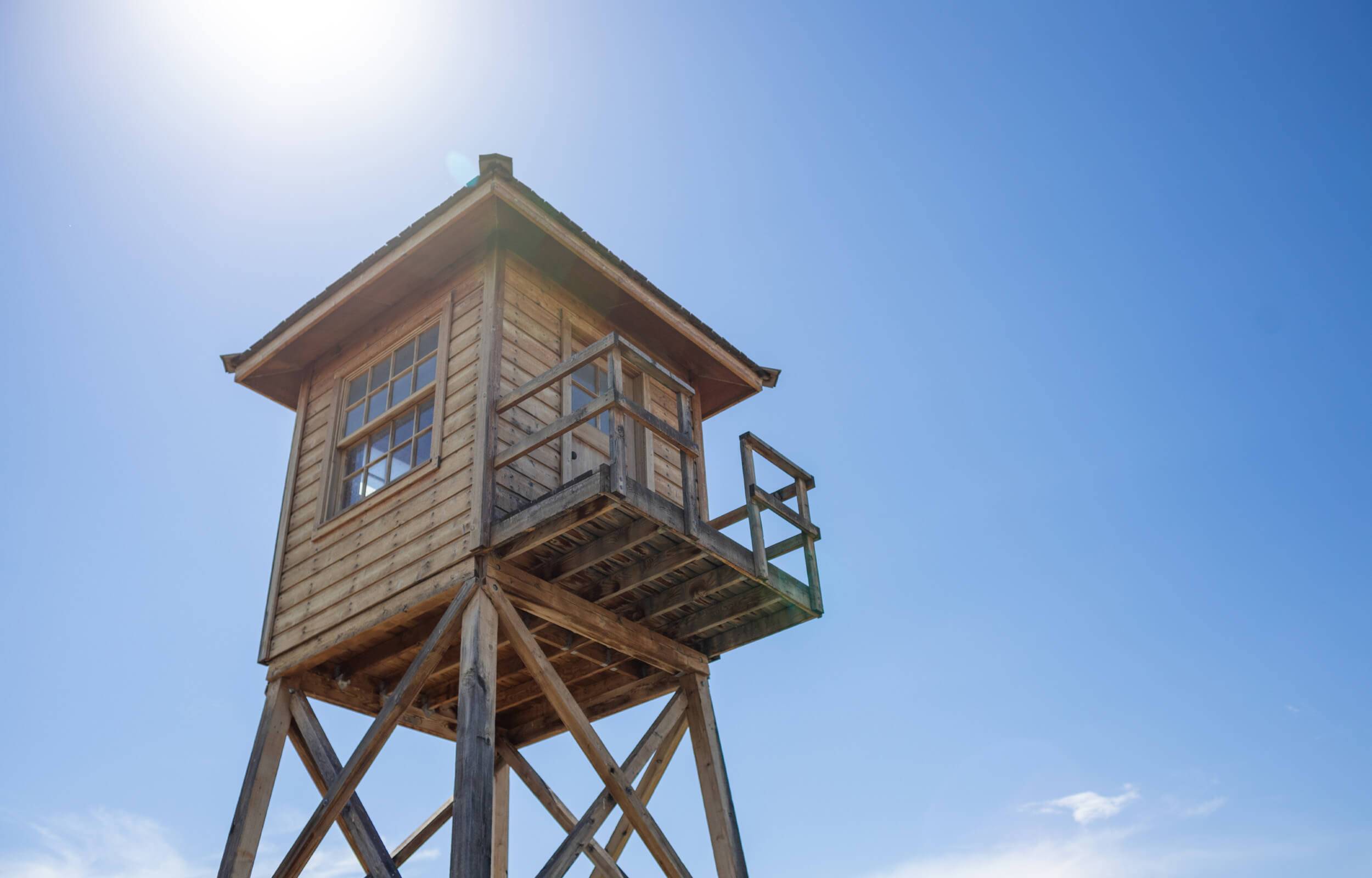 Ground view of a historical wooden guard tower at Minidoka National Historic Site.