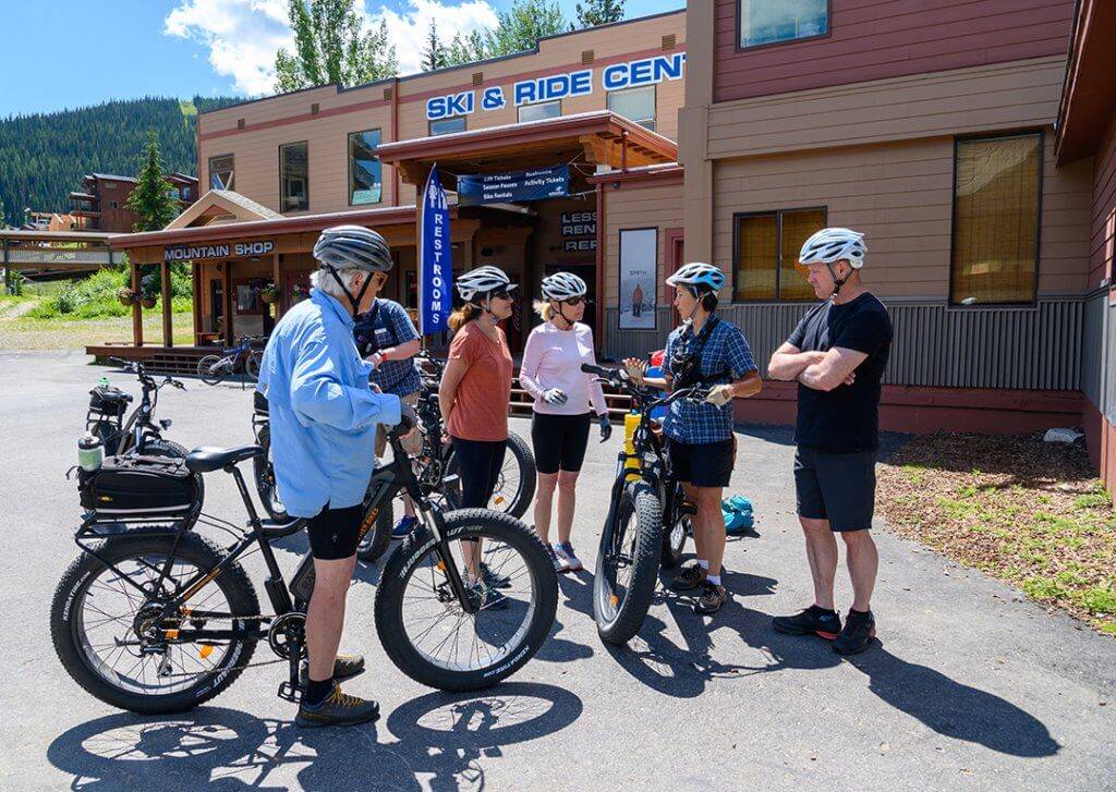 A group of people prepares for an e-bike tour.