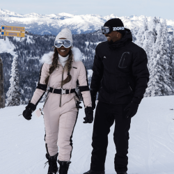 Two people in snow and ski gear standing at the top of the Main Street and North ski run at Brundage Mountain Resort.