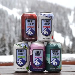 Five Summit Cider cans stacked in a pyramid with a snowy mountain in the background.