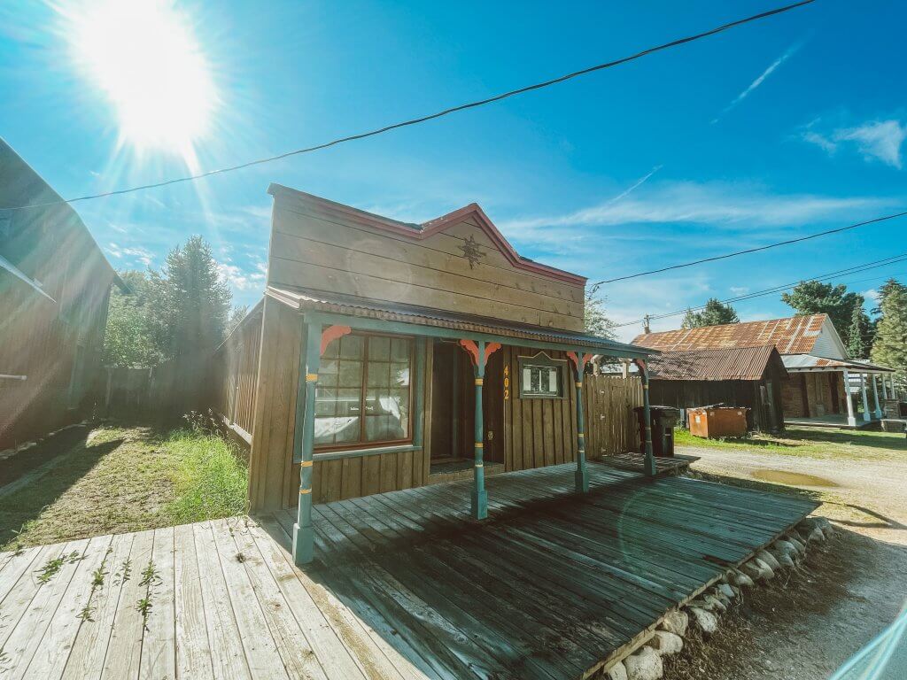 Exterior of historic building with wooden boardwalk in front of home in Idaho City.