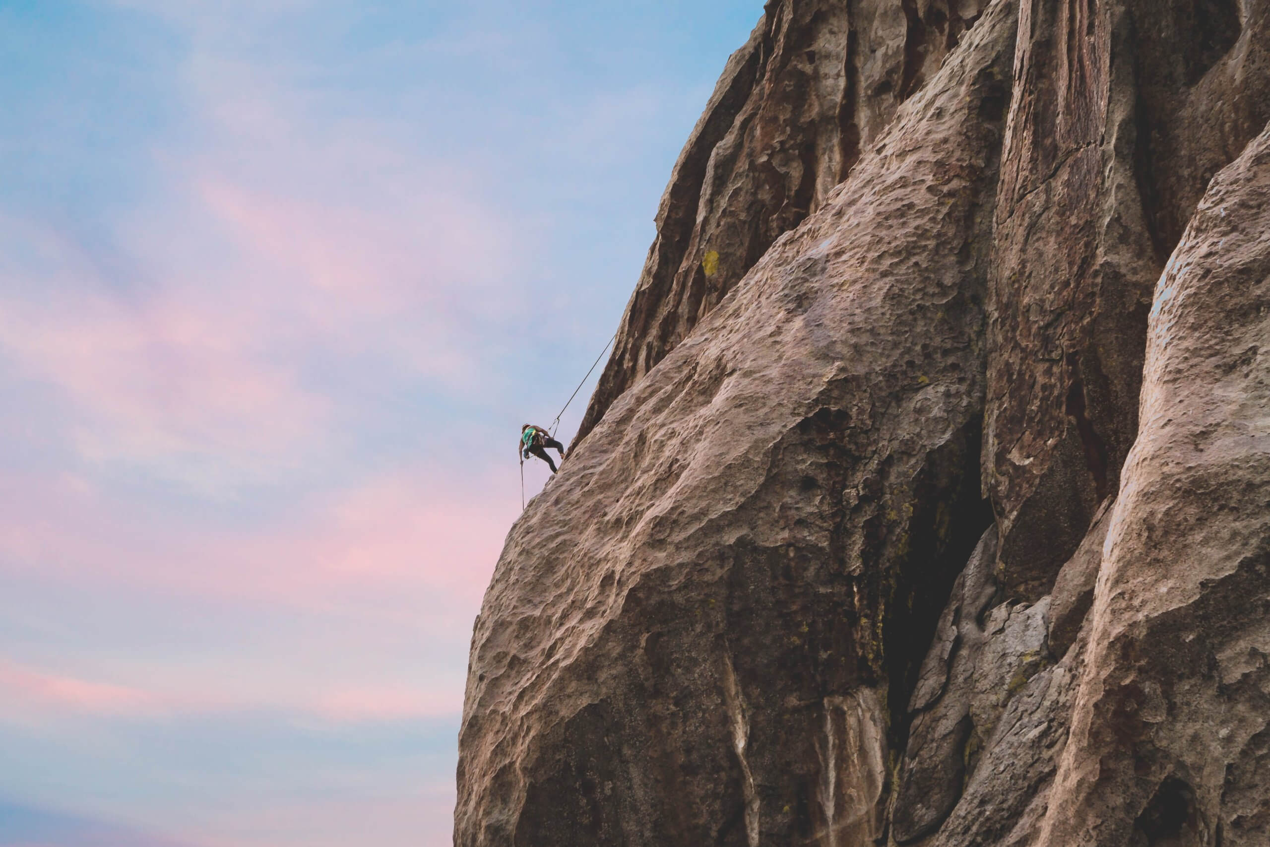 A person propels down the side of a rock formation at Castle Rock State Park.