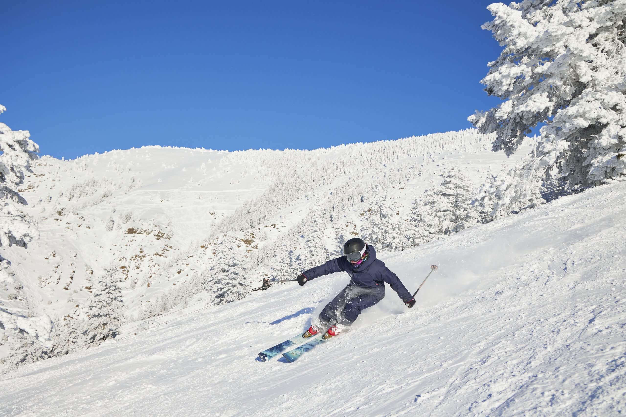 A person skiing down a slope at Pebble Creek Ski Area.