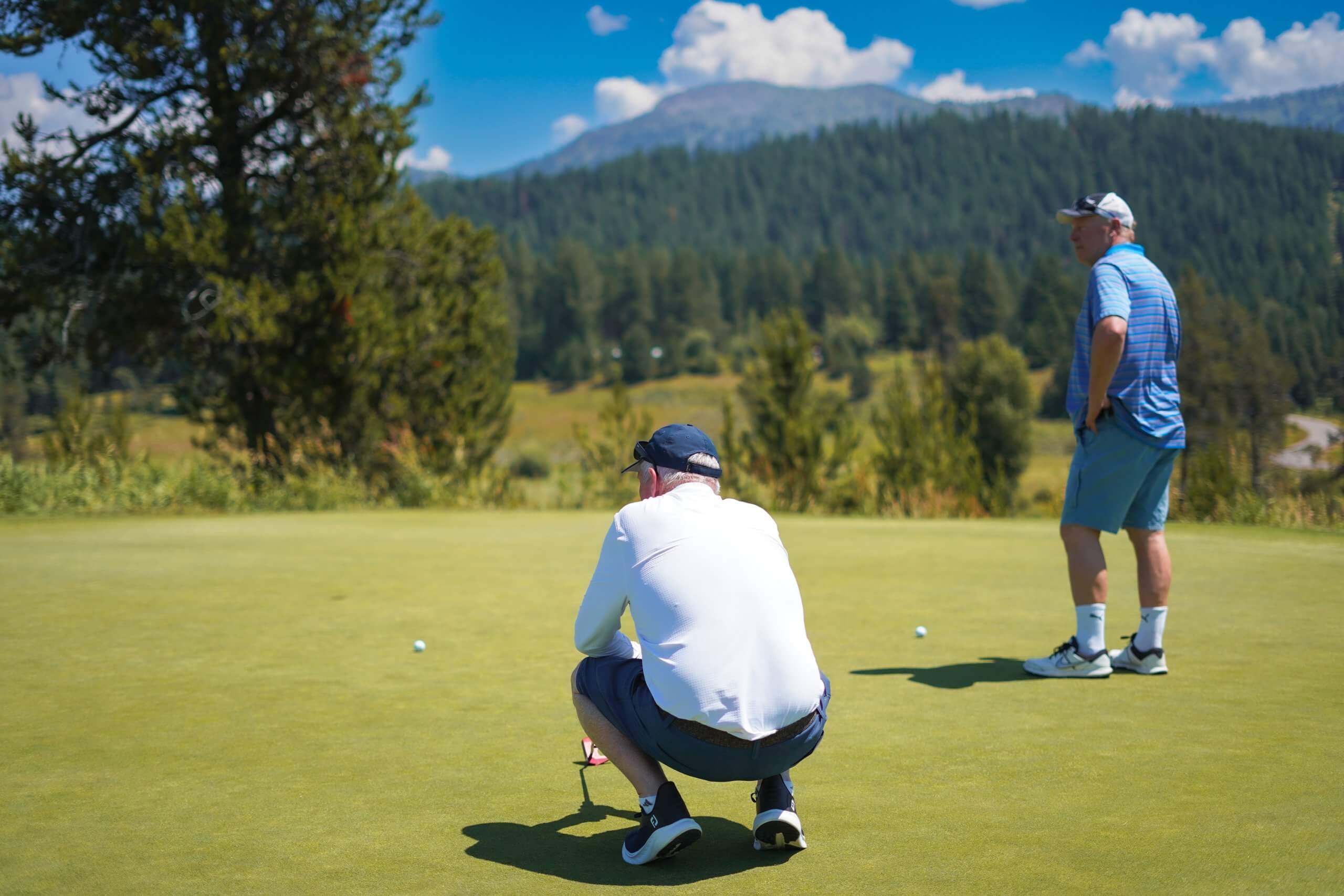 Two men read the greens at Jug Mountain Golf Course.