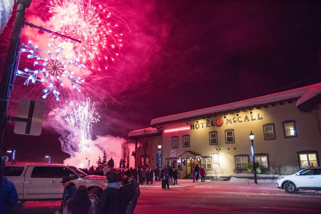 Red fireworks shine over Hotel McCall during the McCall Winter Carnival.