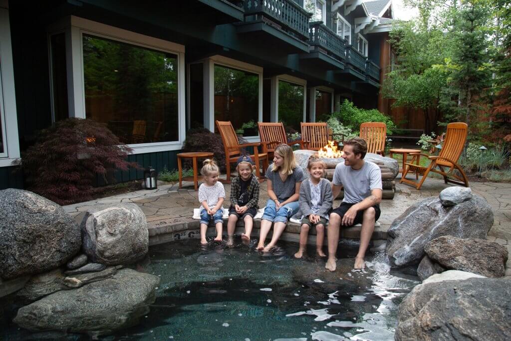 A family of five sit around a hot tub at the Shore Lodge in McCall.