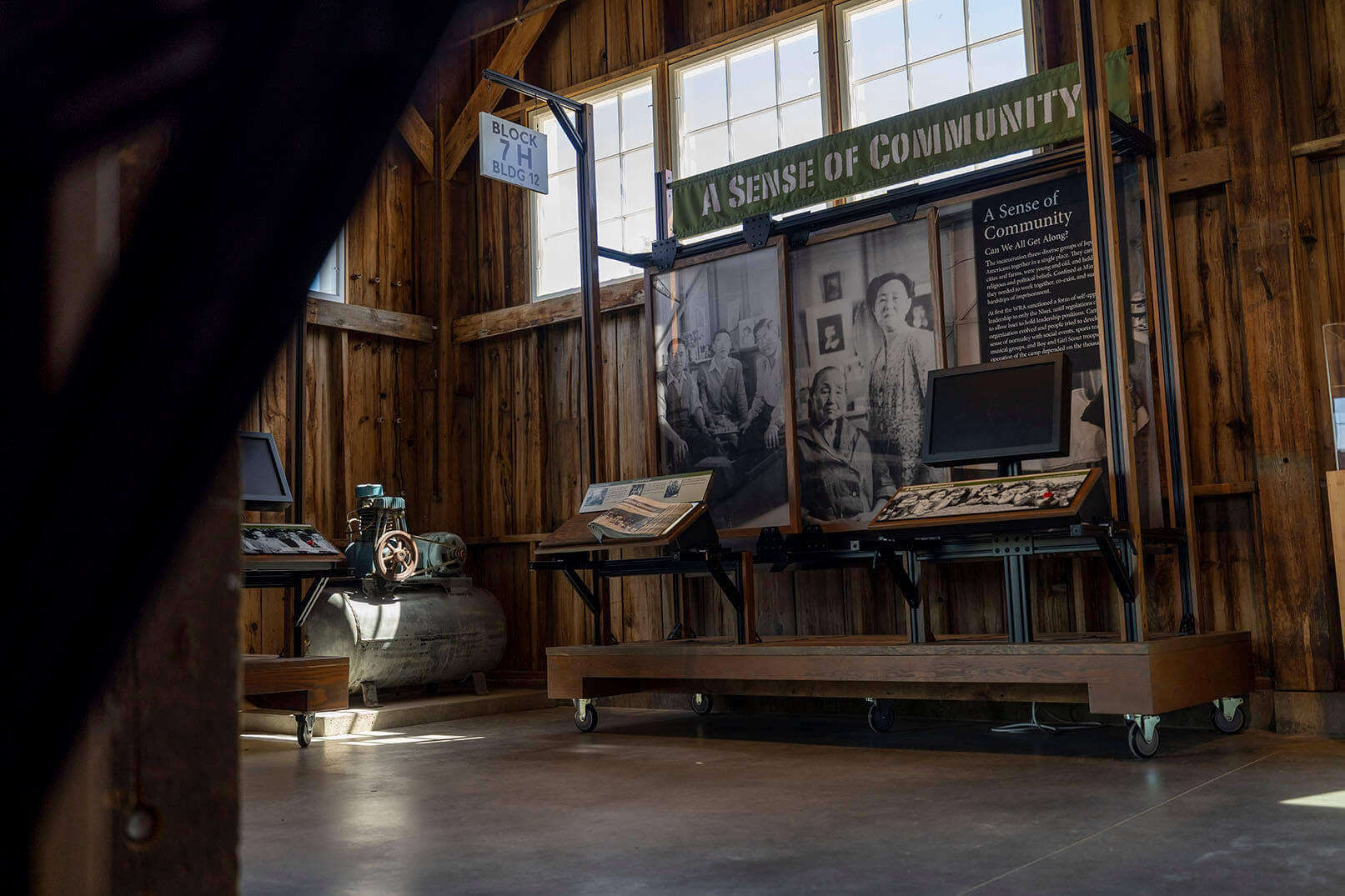 An exhibit titled "A Sense of Community" with historical photos and artifacts in the Minidoka Visitor Center at the Minidoka Historic Site.