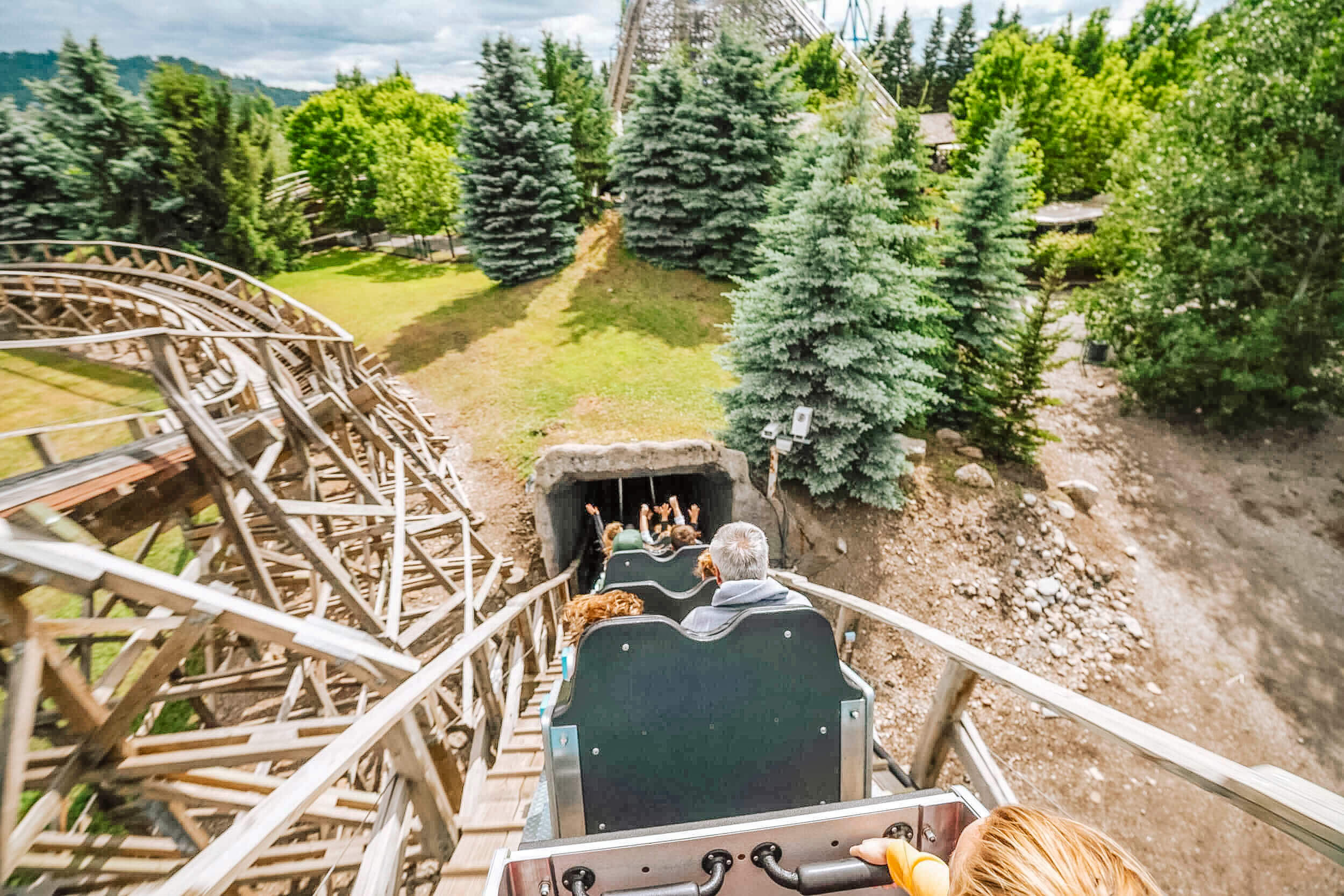 Visitors riding a wooden roller coaster at Silverwood Theme Park.