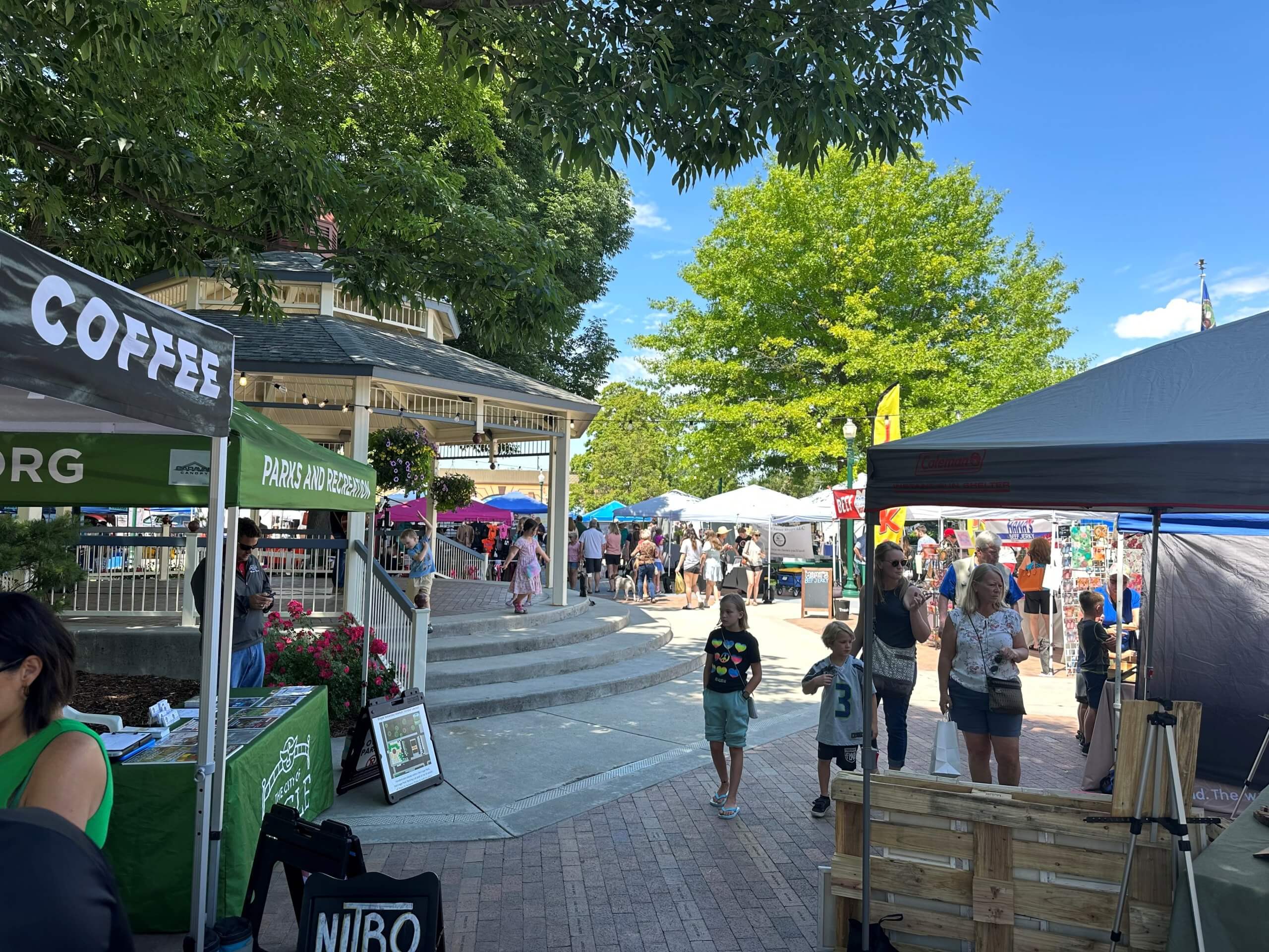 people walk around farmers market