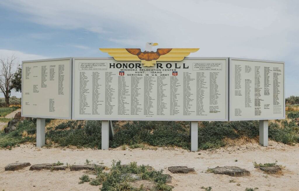 A historical honor roll at Minidoka National Historic Site with trees and shrubs in the background.