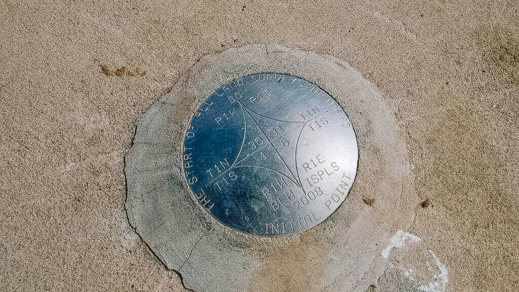 A metal plate marking the Boise Meridian Initial Point.