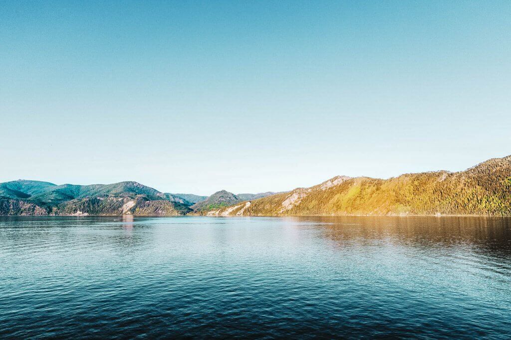 Lake Pend Oreille, surrounded by tree-covered mountains.