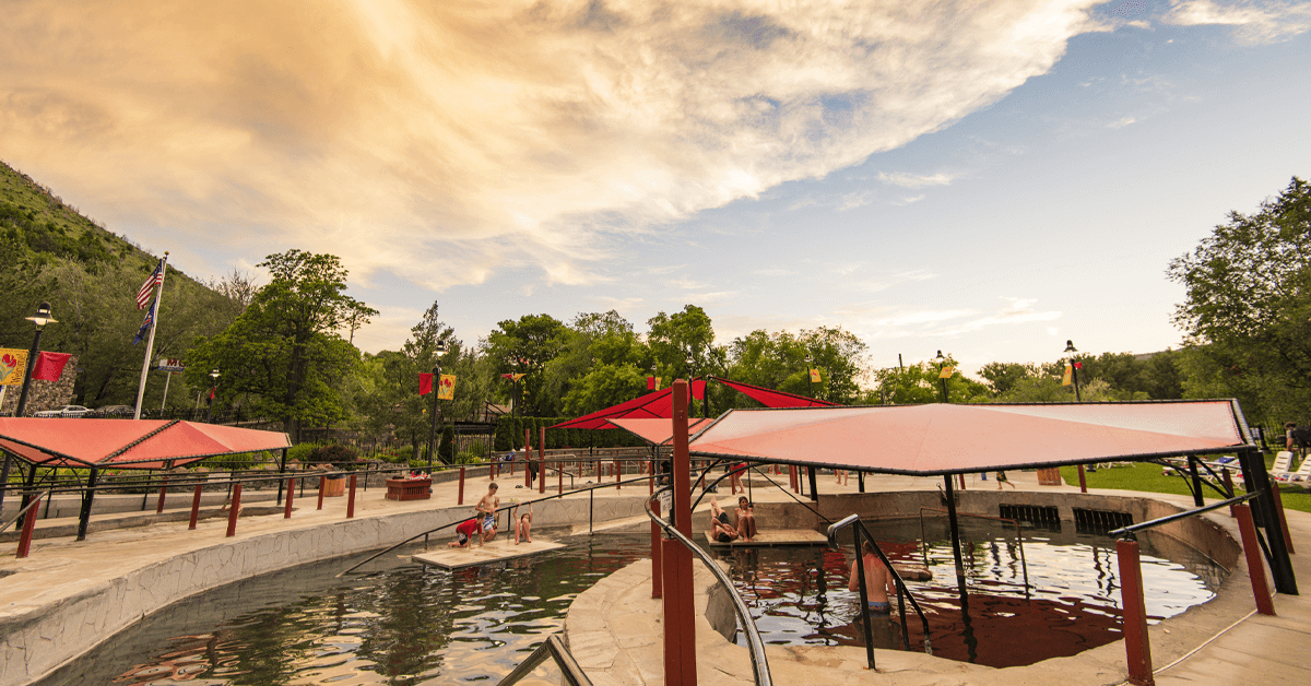 An overhead view of hot pools alongside a river surrounded by trees at Lava Hot Springs.