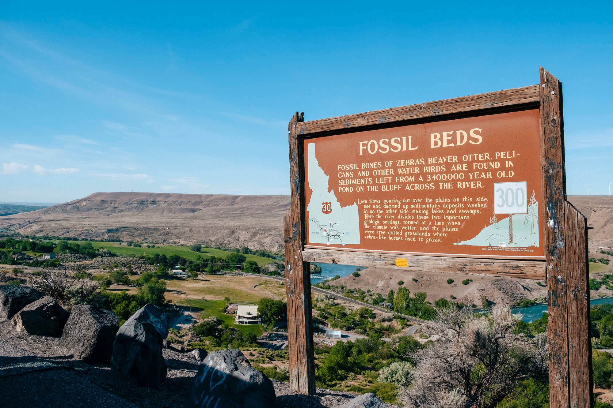 Three people standing on a cliff overlooking Earl M. Hardy Box Canyon Springs Nature Preserve.