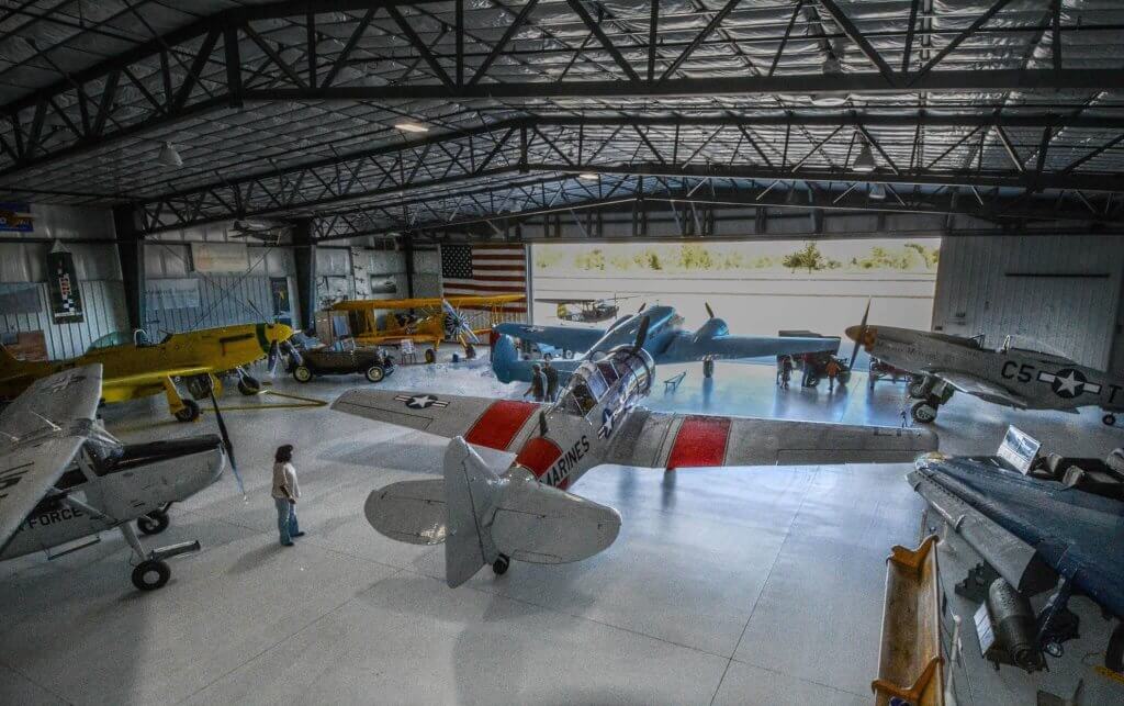 A person looks at airplanes inside a hangar at the Legacy Flight Museum in Rexburg. 