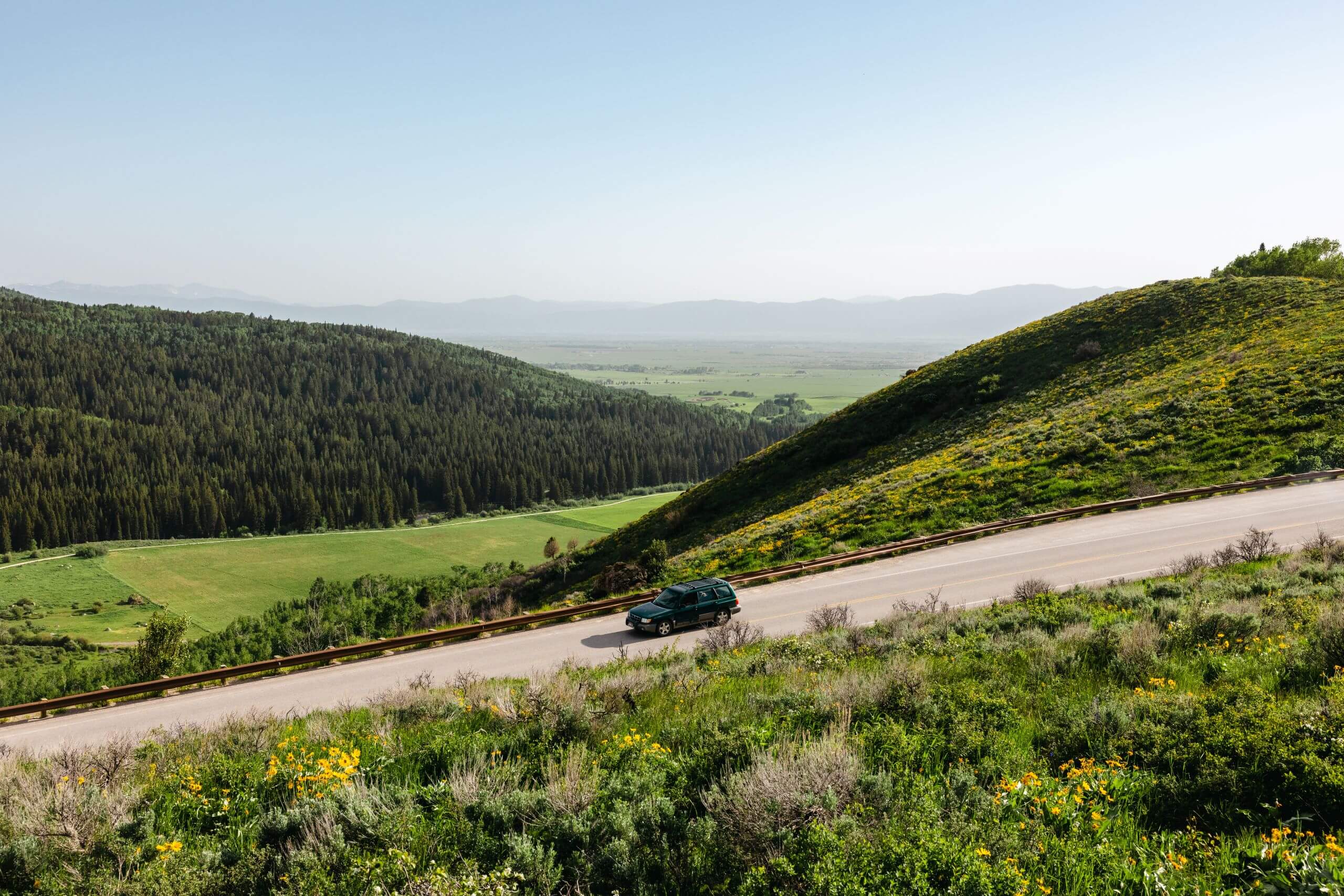 car drives on road in Teton Valley