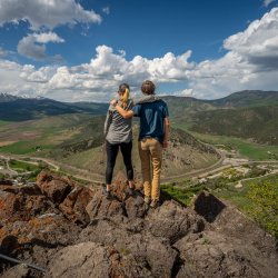 people stand on top of Mount Moh looking at lava hot springs