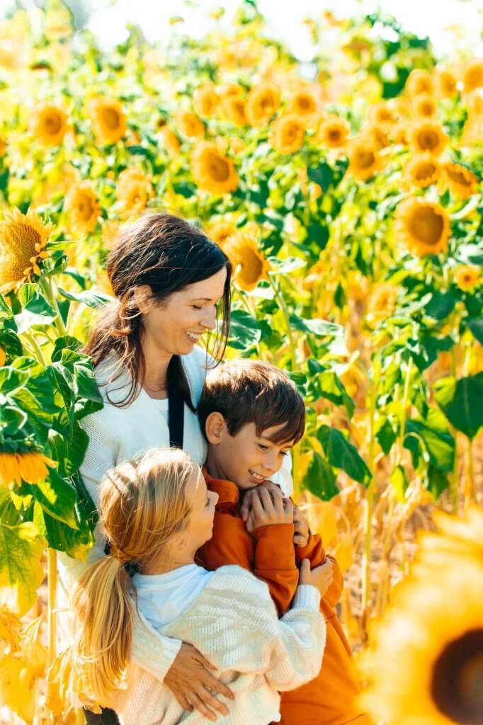 family enjoying sunflowers at Lowe Family Farmstead