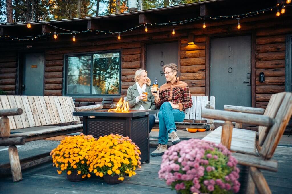 Two people enjoying a cozy evening around a firepit at Scandia Inn