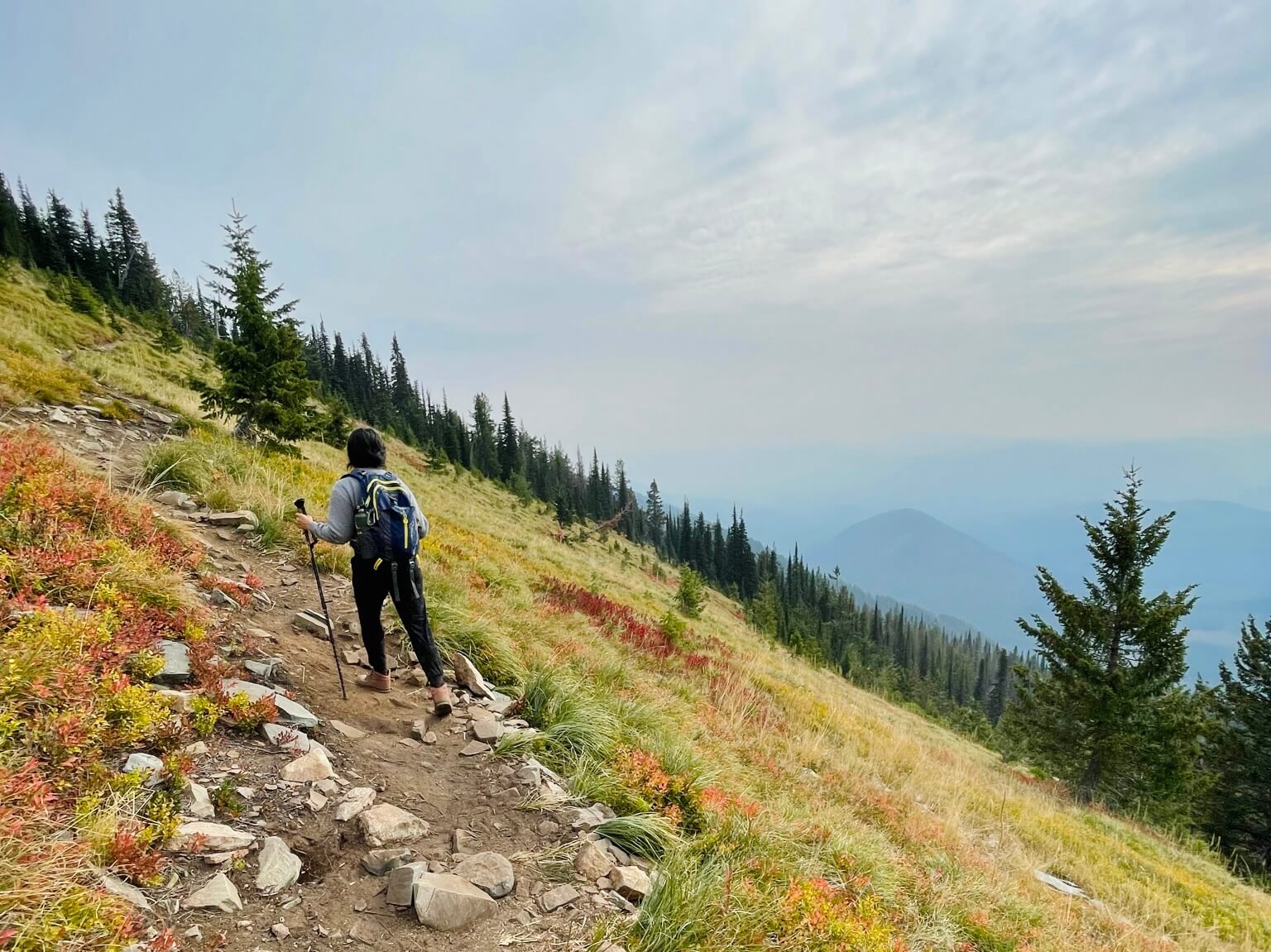 woman hikes on Scotchman Peak trail