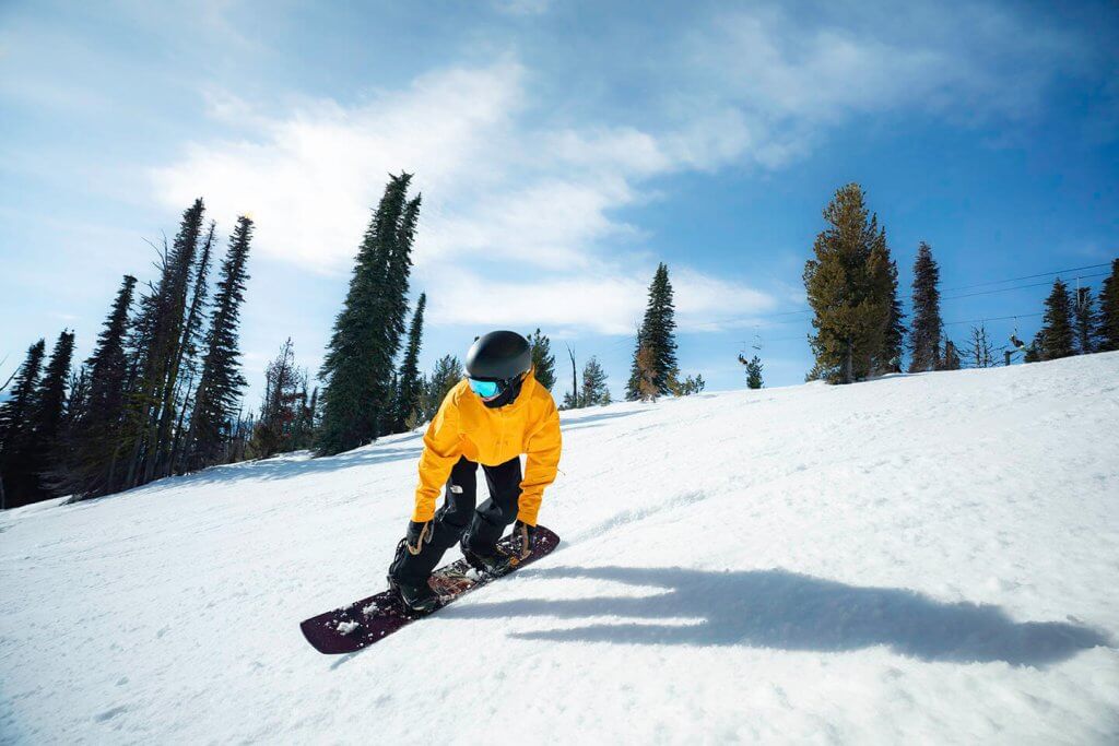 A snowboarder on a winter trail at Brundage Mountain Resort.