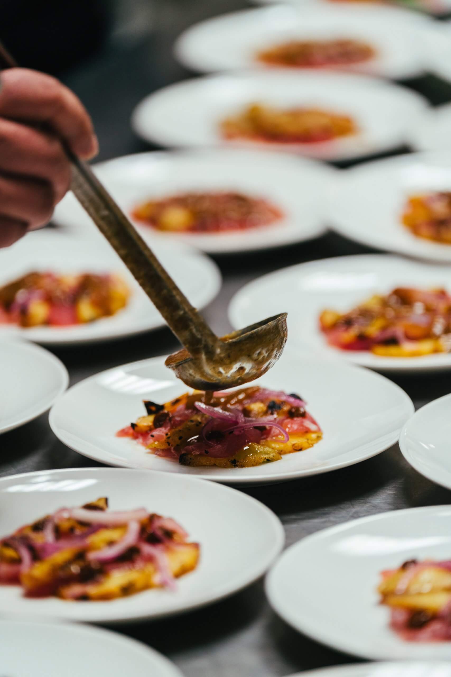 A person plating meals at Foodfort during Treefort.