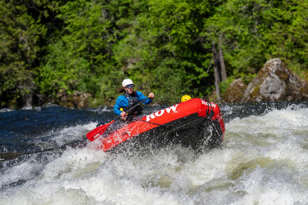 A ROW Adventures guide maneuvers a red raft through rapids on the St. Joe River.