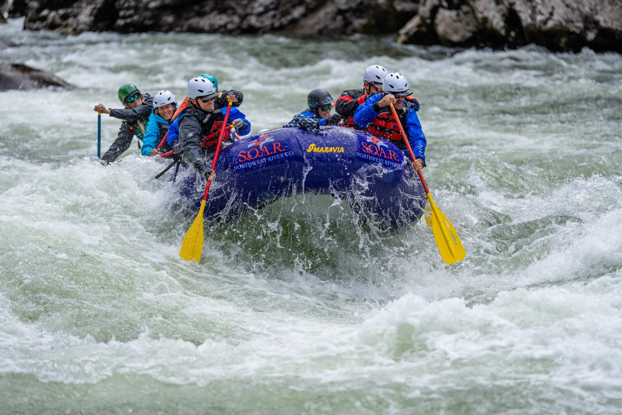 Whitewater rafting group charges through rapids on the Selway River in a SOAR Northwest raft.