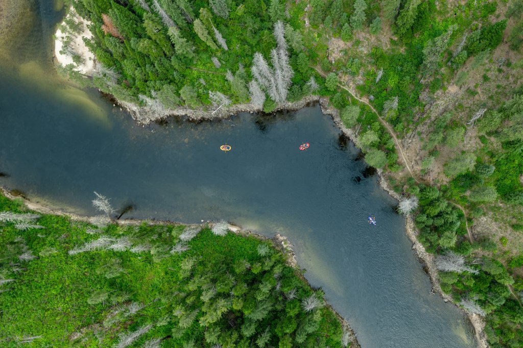 Aerial view of rafts floating down the Selway River through dense Idaho wilderness