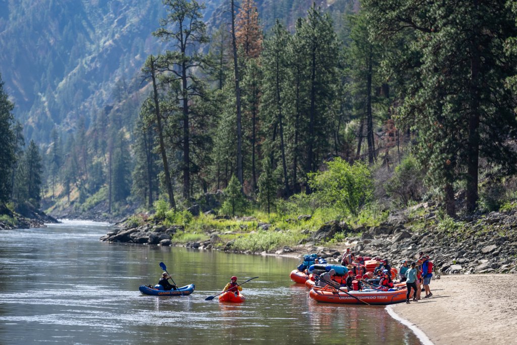 Rafters and kayakers preparing to launch from a sandy beach along the Main Salmon River