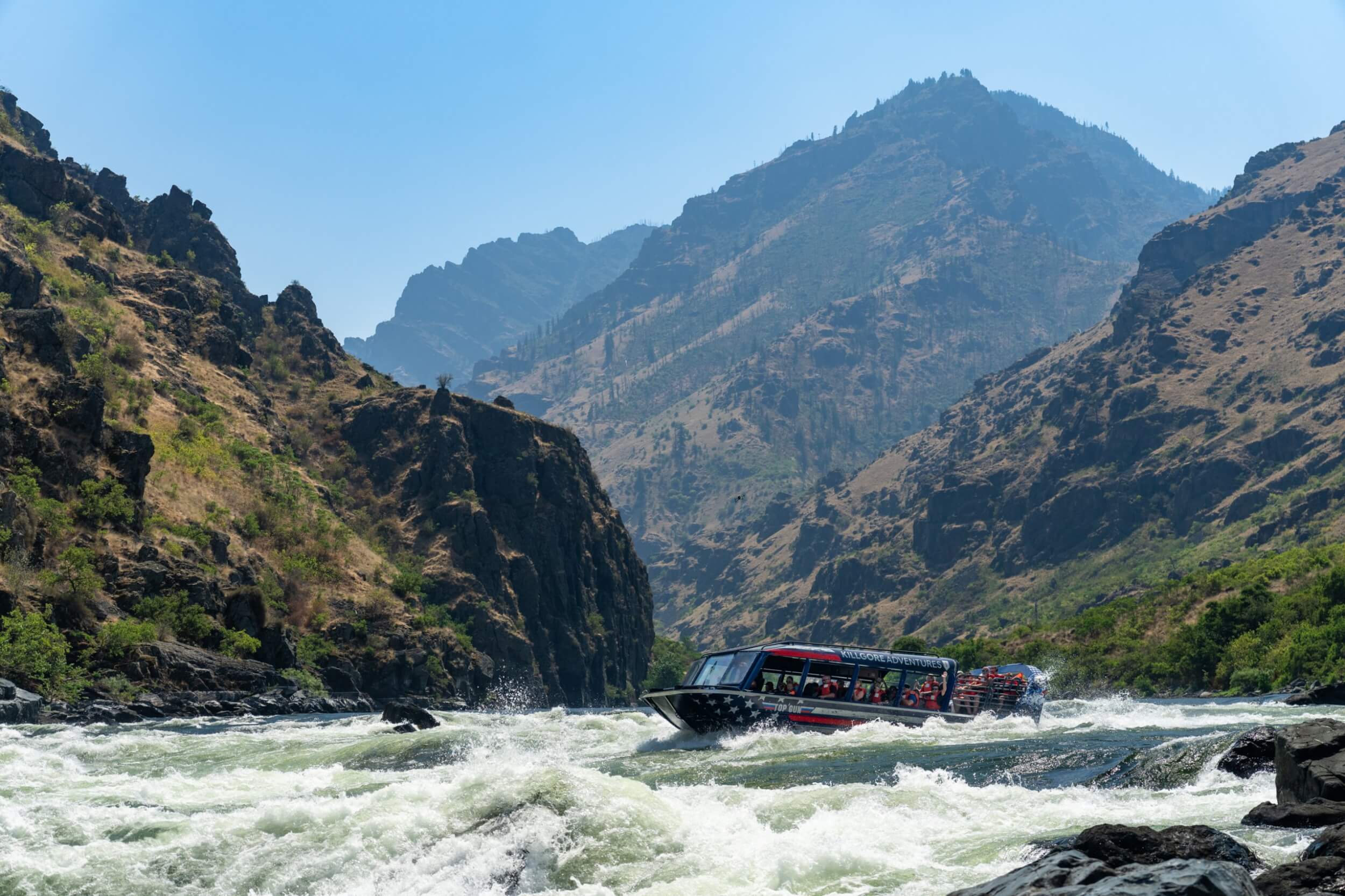 Jet boat navigating whitewater in Hells Canyon on the Snake River with Killgore Adventures
