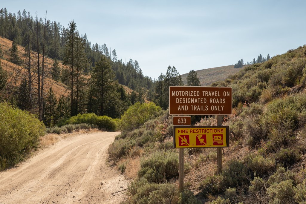 TRAVEL WITH CARE: CAMPFIRE SAFETY A sign displaying fire restrictions.