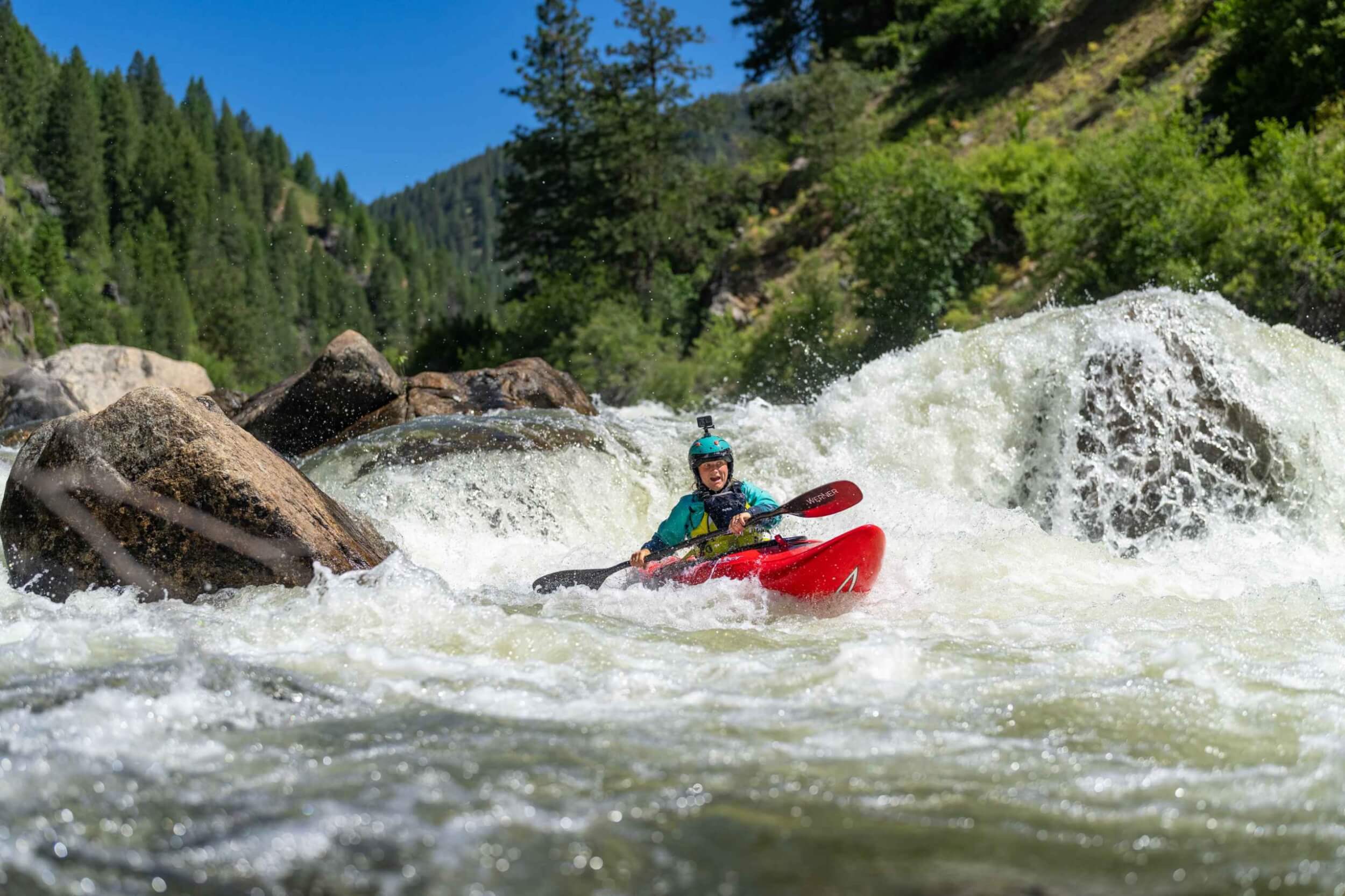 Sage Donnelly, Professional Kayker & Raft Guide drops into a churning rapid on the Payette River.