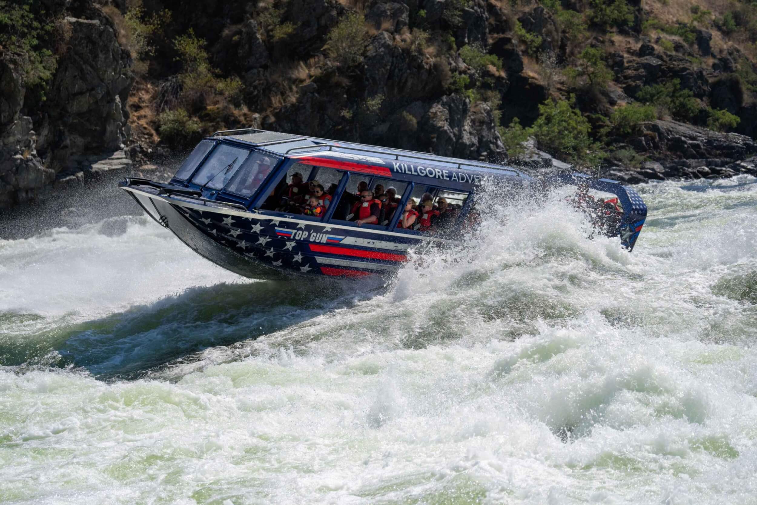 Jet boat launching over whitewater on the Snake River with Killgore Adventures.